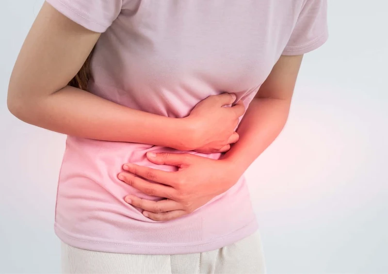Person holding their abdomen in pain